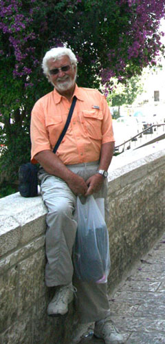 10  Israel, Jerusalem. Gunter sits on wall in Old City.